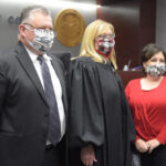 Bane and White flank Judge Scott